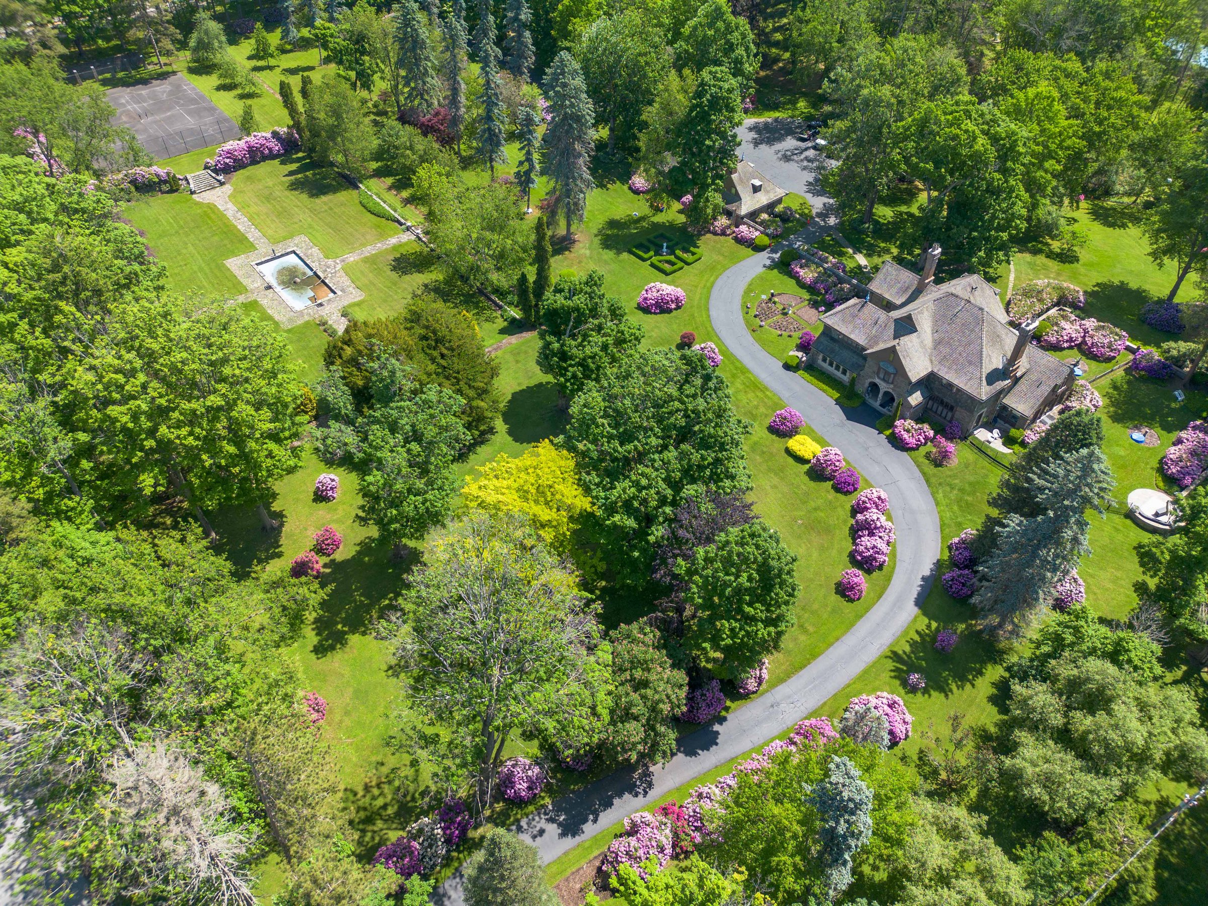 Aerial view showing the carriage house among trees