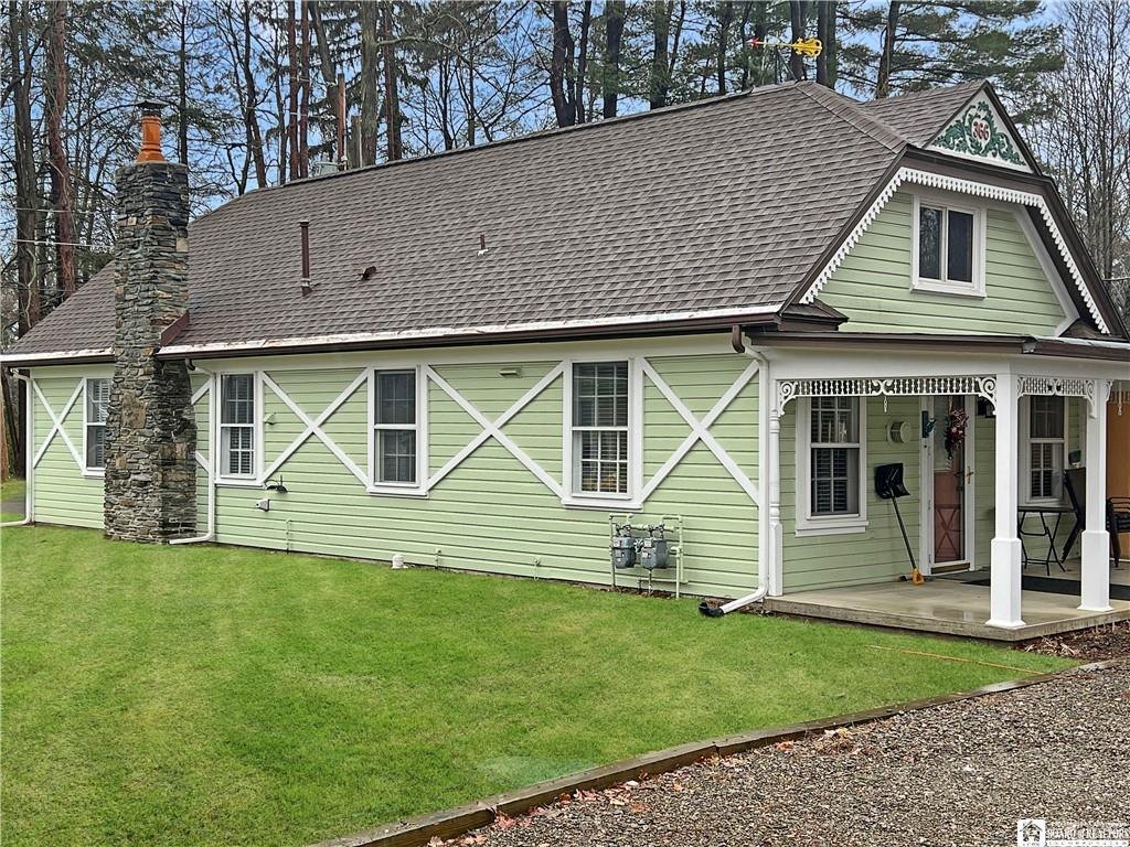 Rose Garden Cottage — green Victorian-style cottage on the property